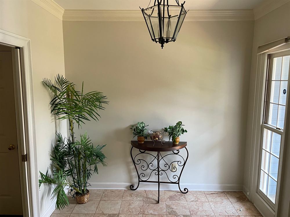 Finished Tillman House lobby with warm neutral walls, crown molding and tile flooring