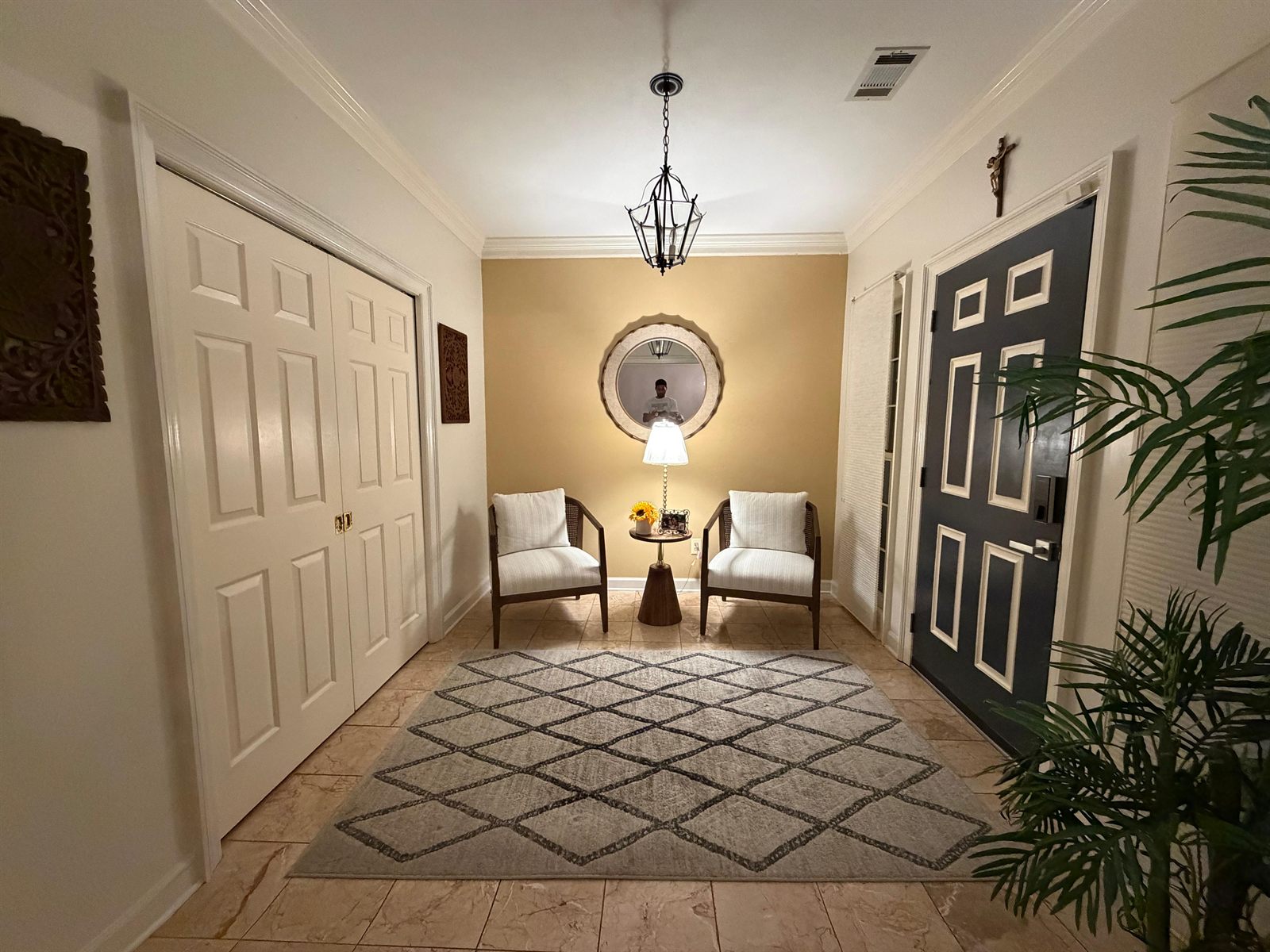 Finished Tillman House lobby with painted doors, wall mirror, chandelier and matching furniture